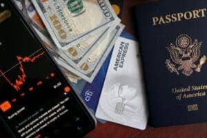 Stock trading concepts with passport, credit cards, cash, and smartphone app image.