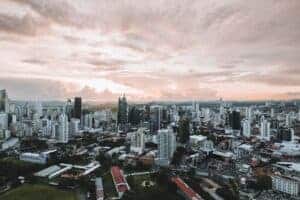 Dramatic aerial view of Panama City skyline during sunset showcasing modern skyscrapers.