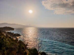 Breathtaking view of a sunset over the Mediterranean Sea in Ksamil, Albania, capturing tranquil waves and vibrant skies.