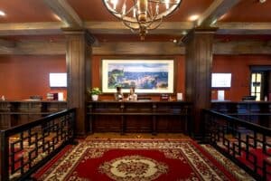 Elegant and luxurious hotel reception with classic wooden design and plush carpeting.