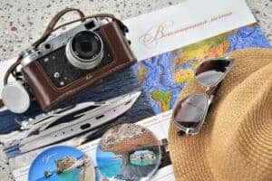 Explore travel with a vintage camera, map, and accessories perfect for a getaway.