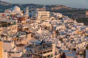 Breathtaking sunset over Santorini's unique white architecture and scenic cityscape.