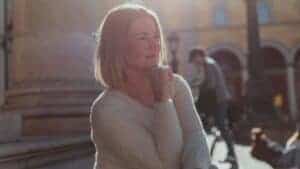 A middle-aged woman enjoying a sunny day outdoors in Munich, Germany.