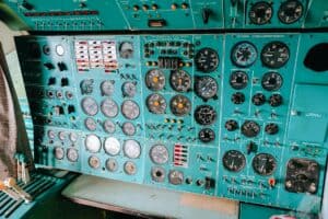 Detailed view of a vintage aircraft control panel with dials and gauges.