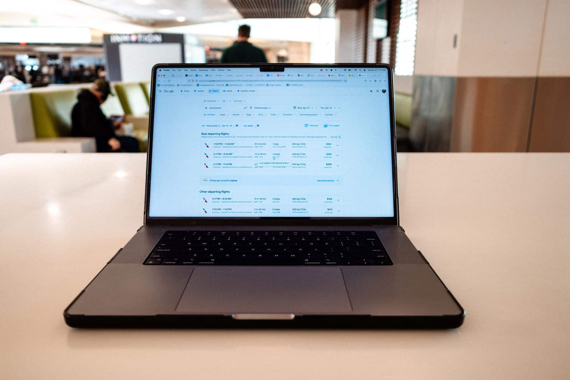 person booking flight laptop