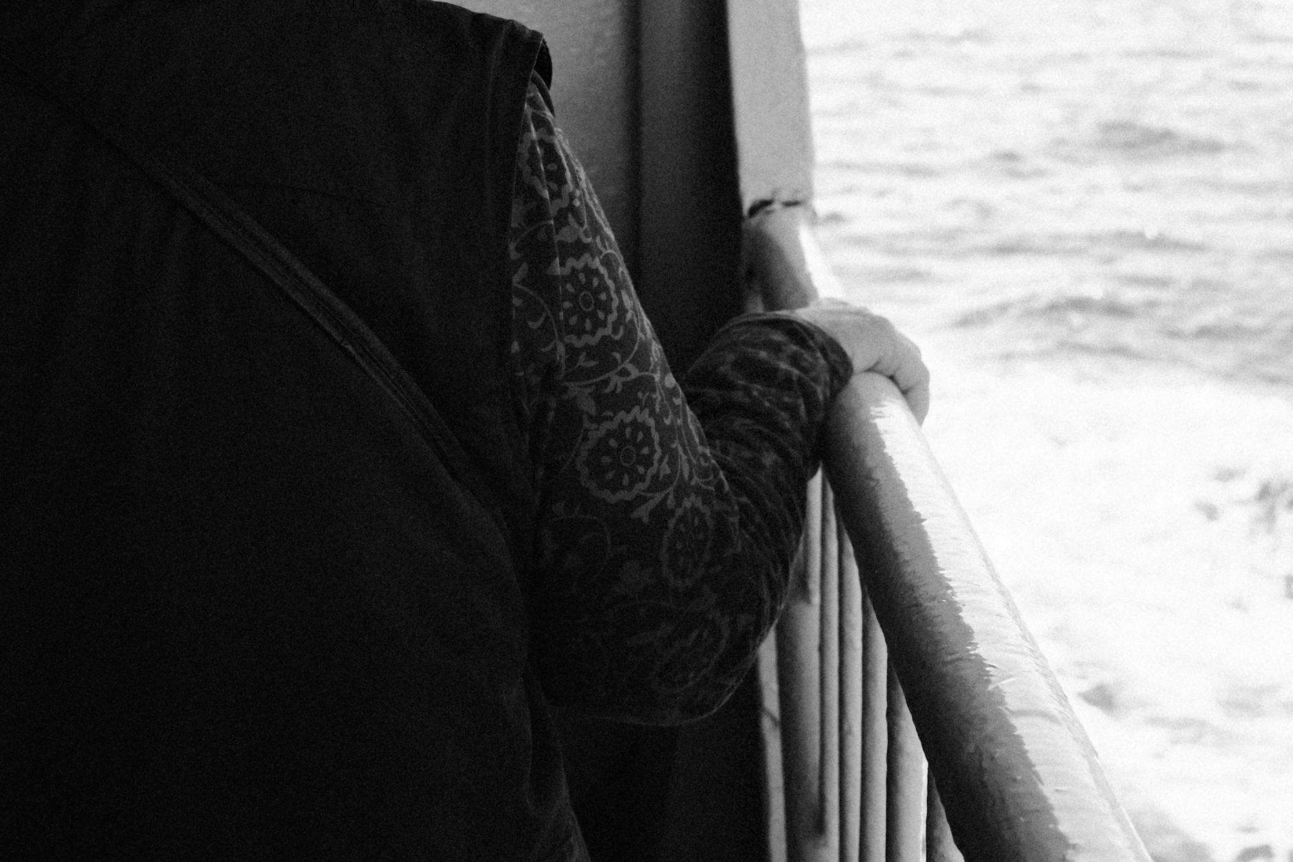 person cruise ship railing sad