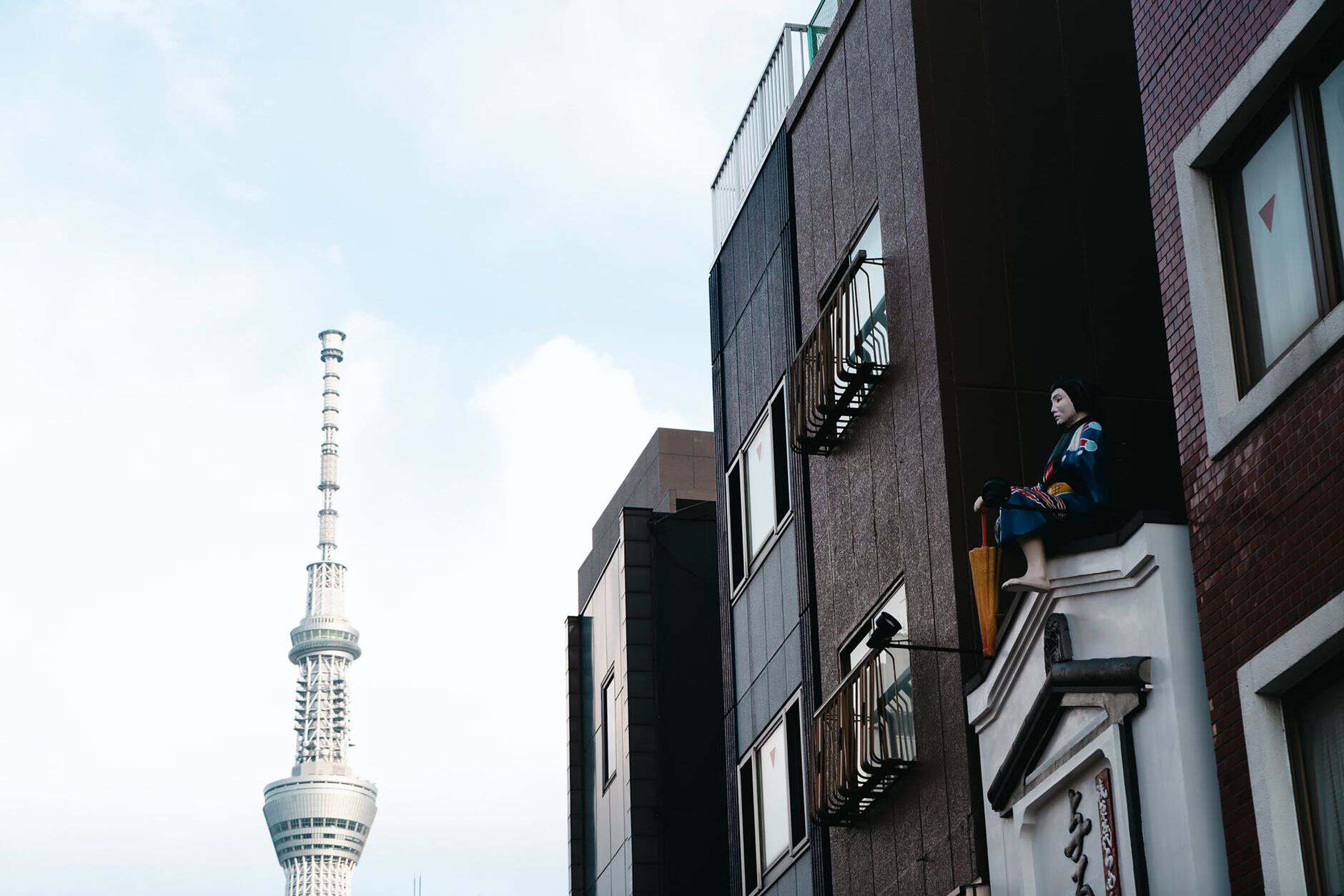 View of Tokyo Skytree beside traditional urban architecture in Tokyo, Japan.