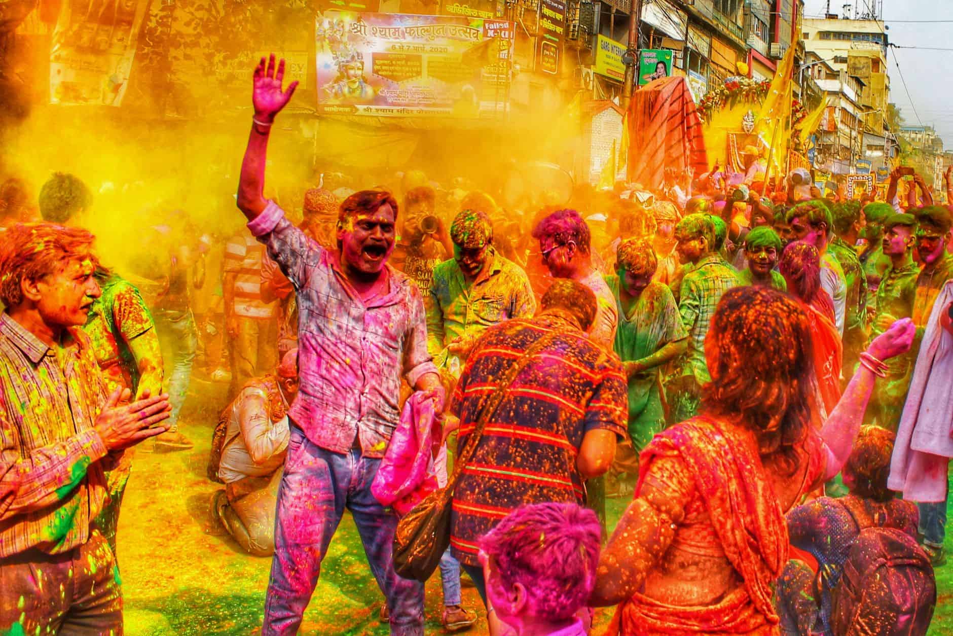people in festival with colorful powder