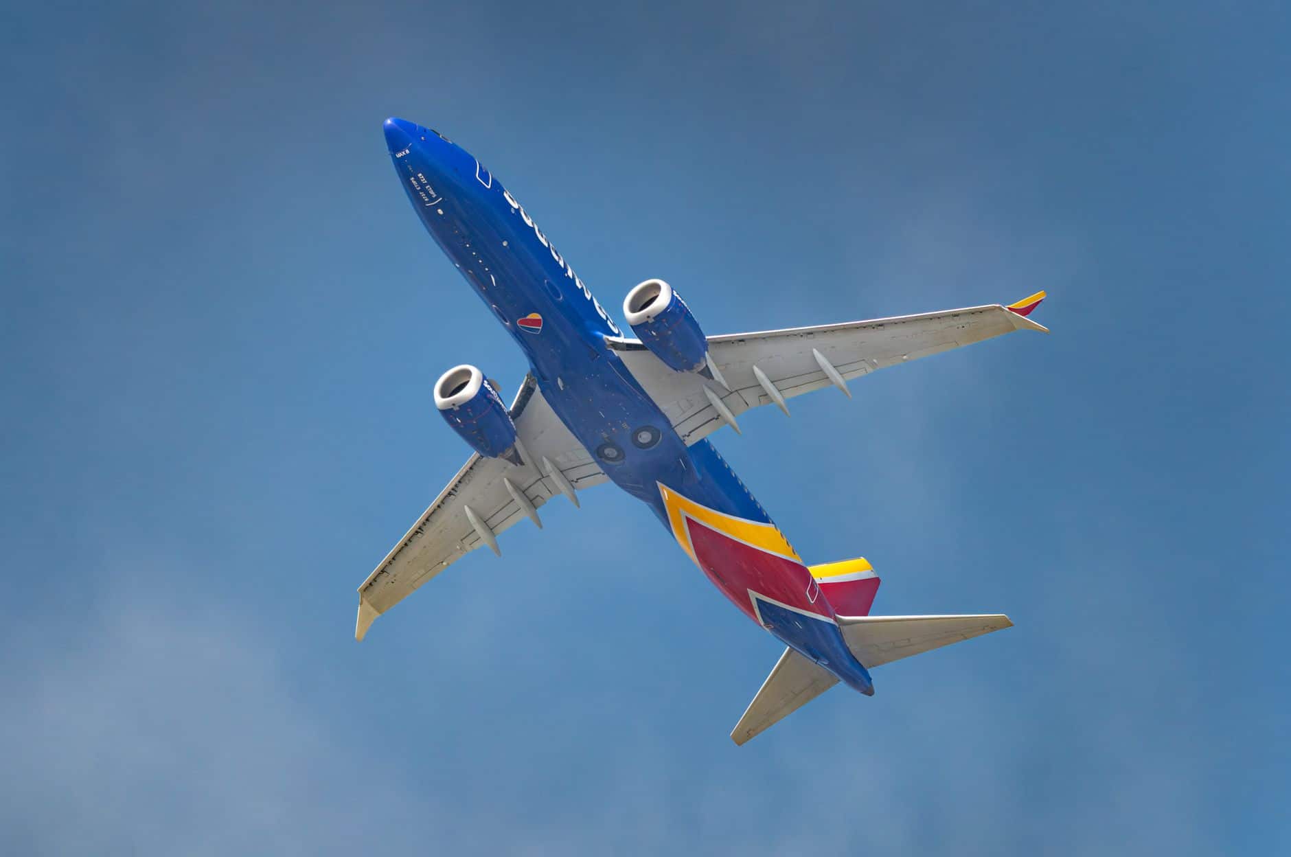 dynamic aircraft in blue sky captured from below