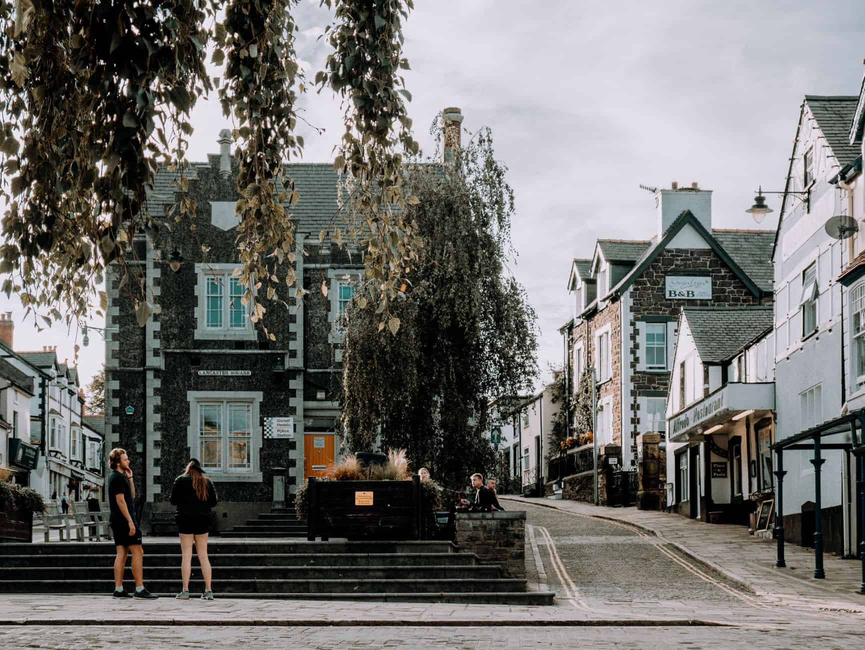 Discover the quaint charm of a village street with historic architecture, cobblestones, and a peaceful ambiance.