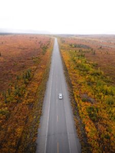 Car driving the Parks Highway toward Denali in Alaska