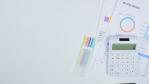 Person calculating a cruise vacation budget with a calculator