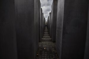 Visitors walking through a memorial site associated with dark tourism