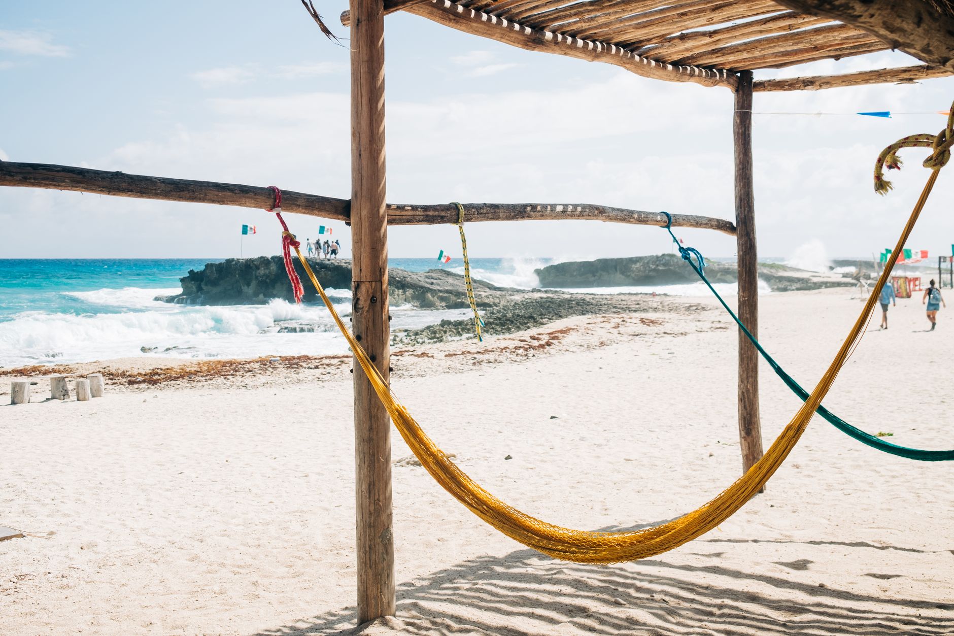 Person relaxing in a hammock on a quiet beach