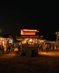 Iowa State Fair midway with rides and crowds at dusk