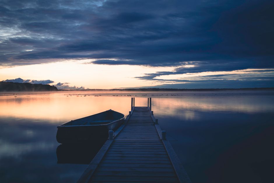 Dock on quiet Midwest lake at sunset
