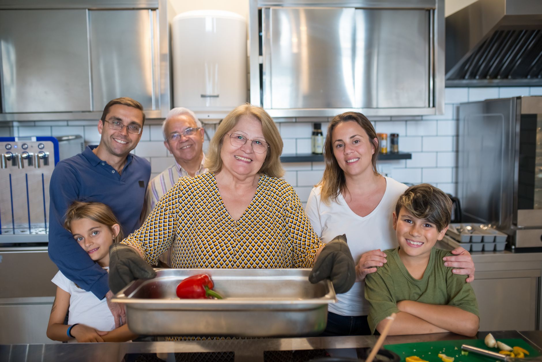 Multi-generational family working in restaurant kitchen