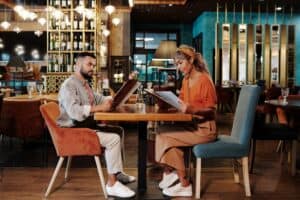 Couple looking at a restaurant menu while traveling