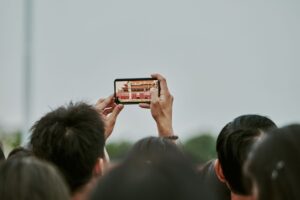 Tourist photographing a landmark among a crowd of visitors