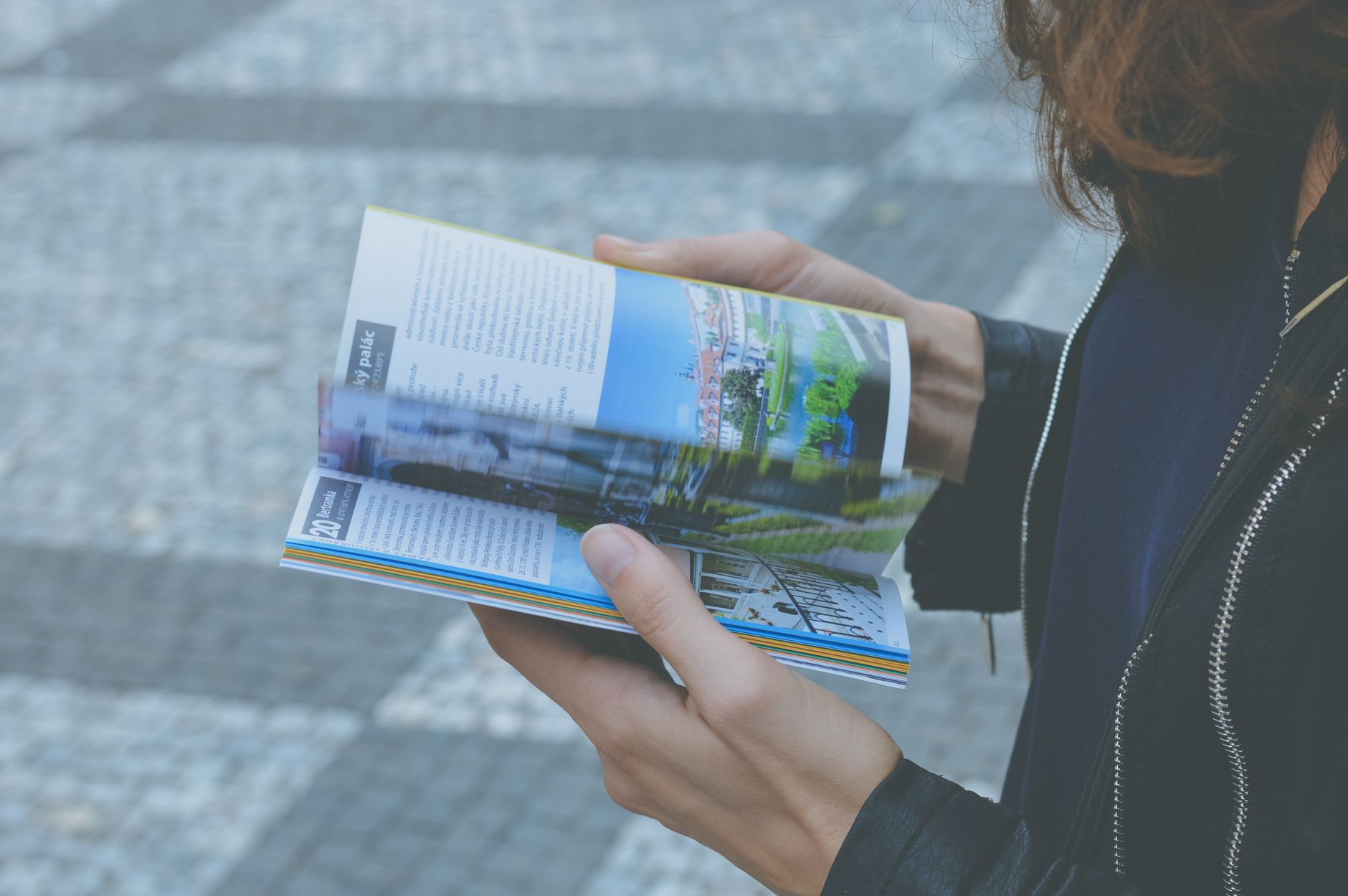 Traveler consulting a printed guidebook and local map
