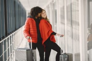 Traveler comparing luxury and budget travel options at airport