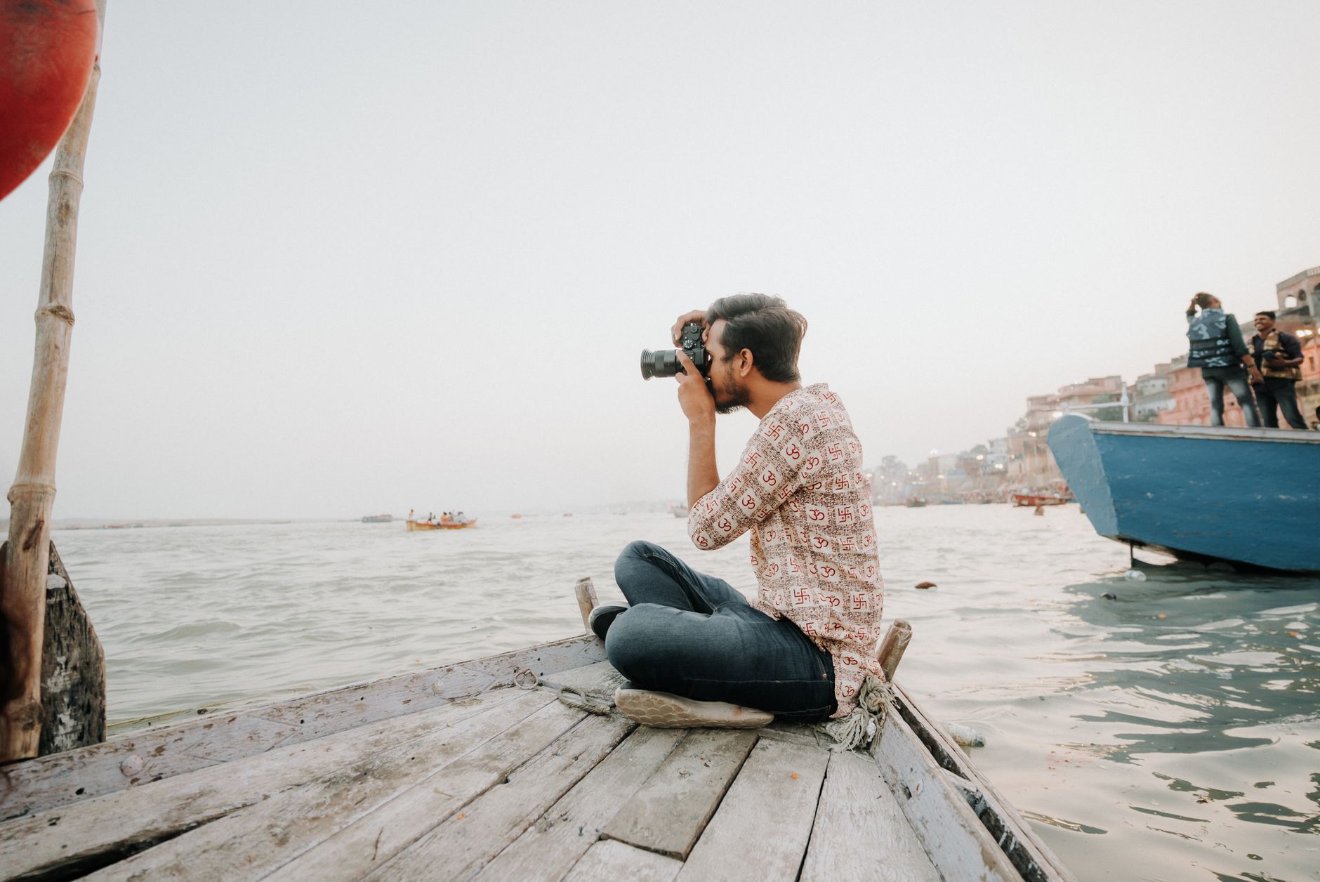 Traveler capturing a scenic photo at sunset