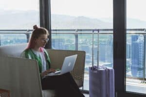 Traveler alone hotel room laptop