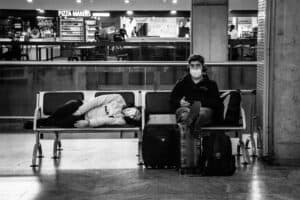 Exhausted traveler at the airport at the end of a trip