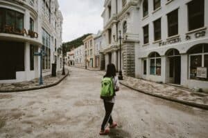 Traveler walking casually through a city neighborhood
