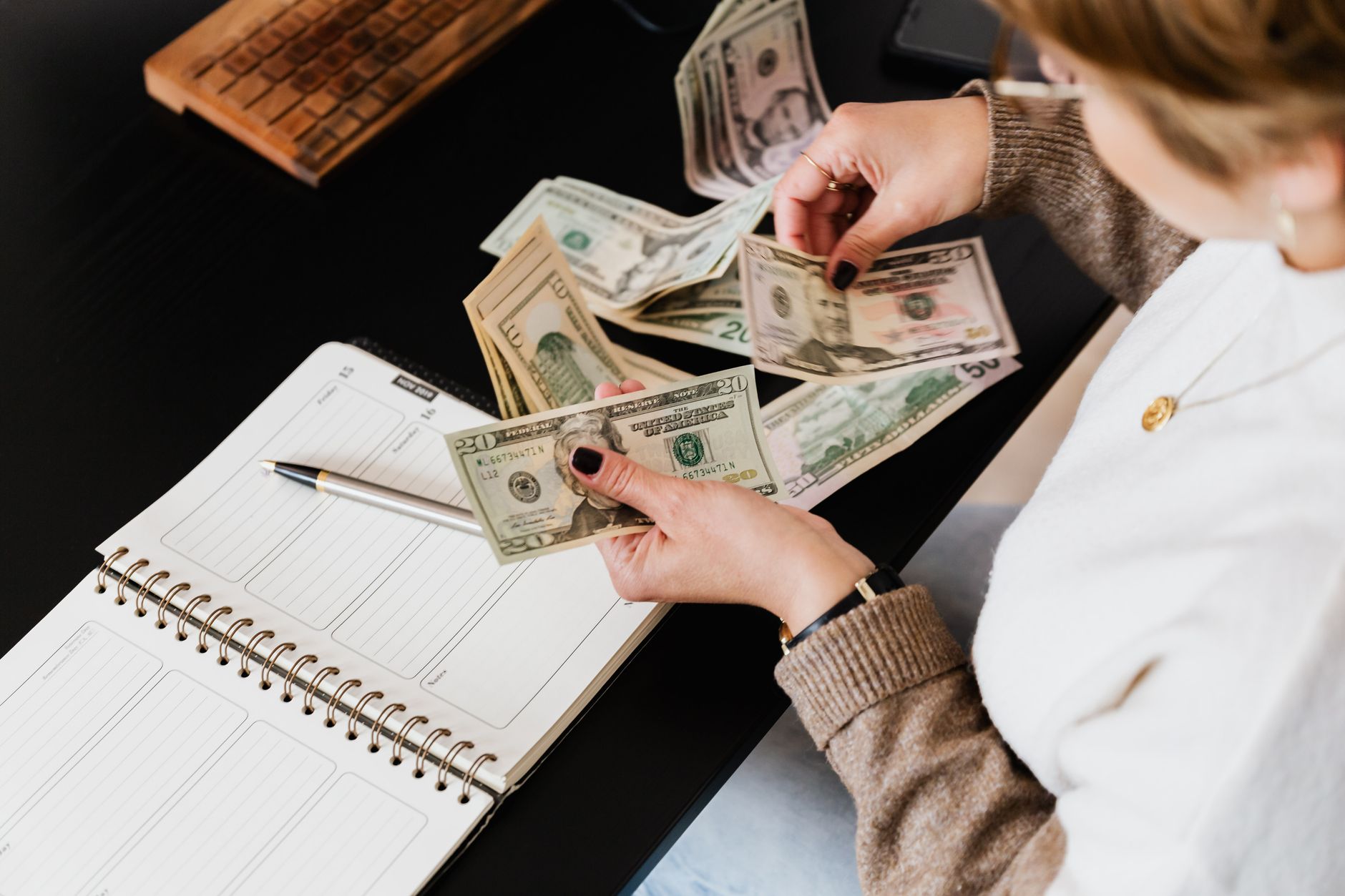 Traveler reviewing travel budget notebook