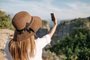Traveler taking a photo at a scenic viewpoint