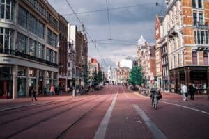 Pedestrians walking on a tree-lined city street