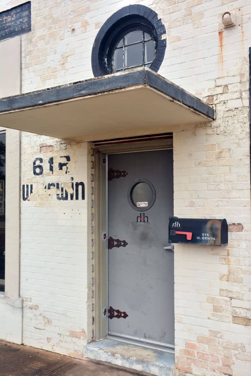 Explore a vintage Art Deco style building entrance on Erwin Street, Tyler, TX.
