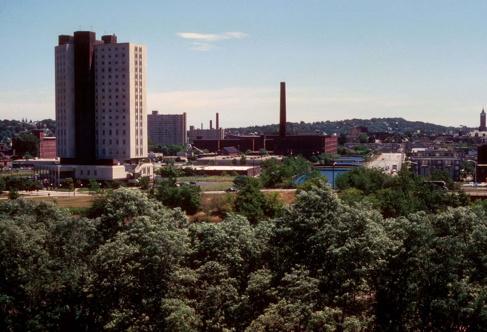 Skyline of Lowell, Massachusetts with prominent buildings and smokestacks.