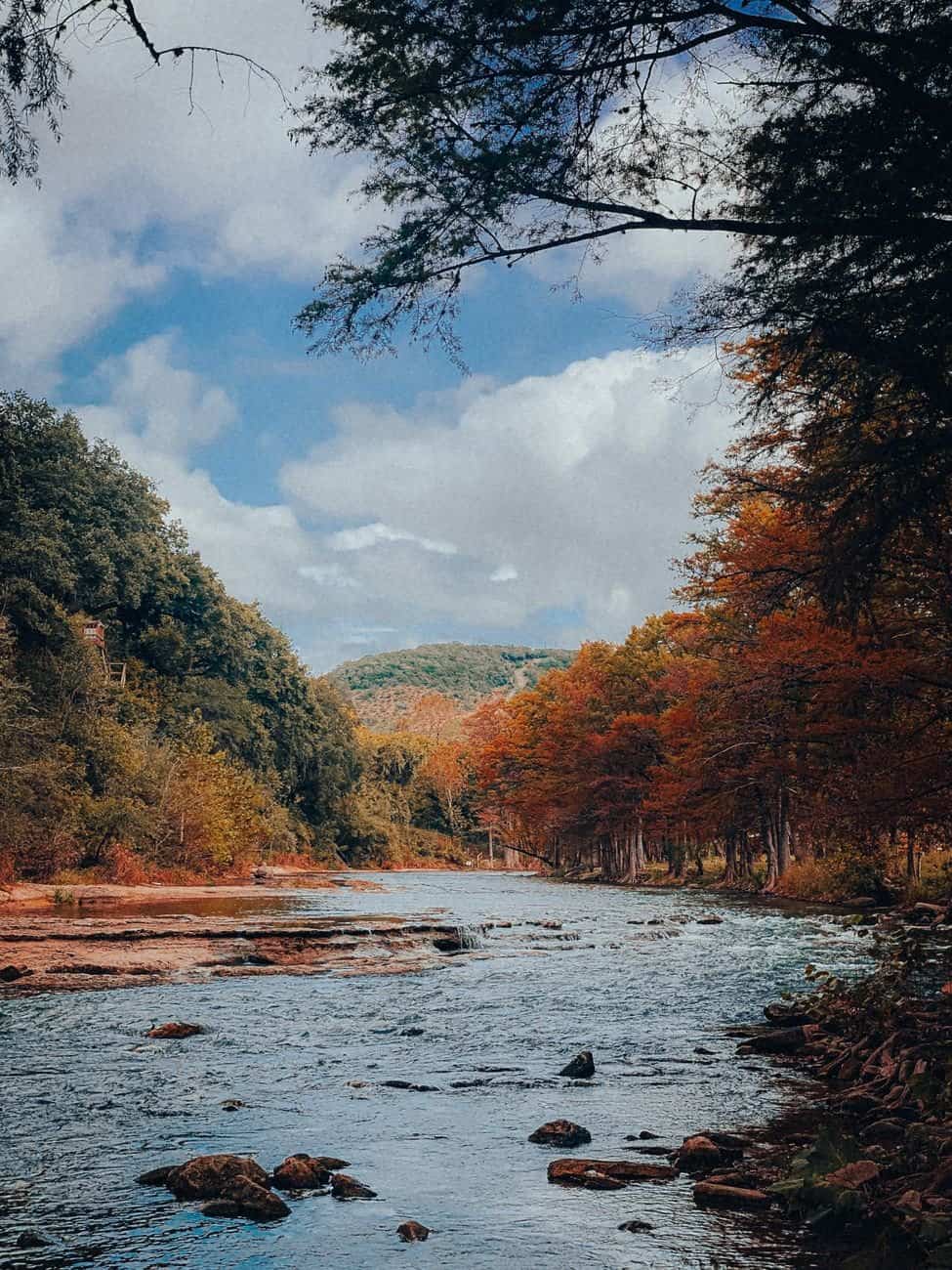 Beautiful view of the river surrounded by autumn foliage in New Braunfels, Texas.