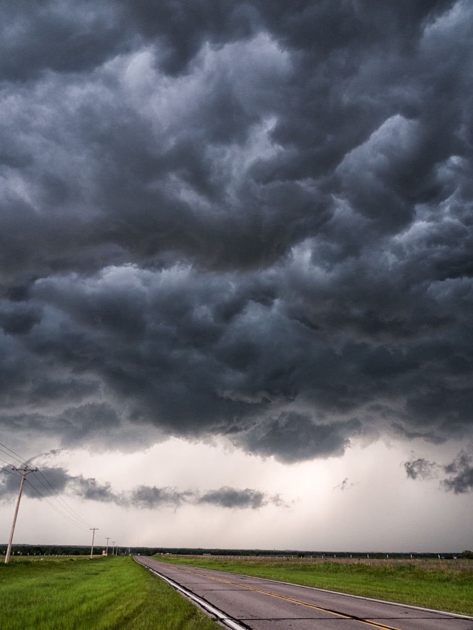 A powerful storm approaches over a desolate rural road in Buffalo, Oklahoma.