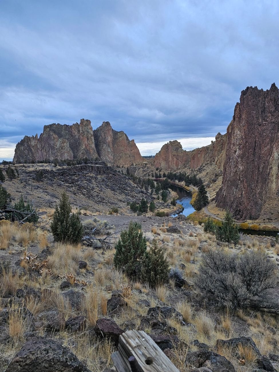Dramatic landscape of Smith Rock State Park with rugged cliffs and a winding river.