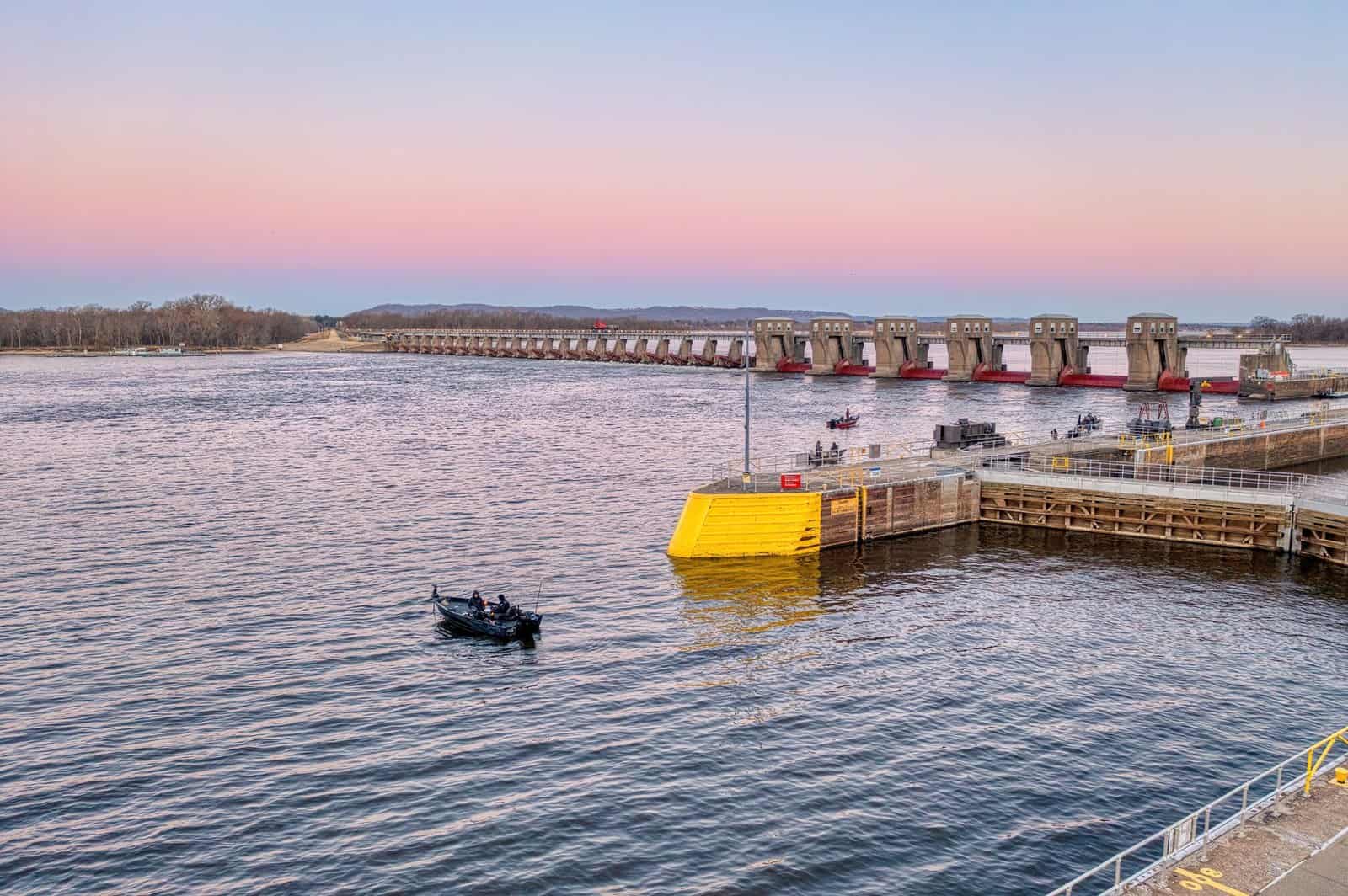 Scenic sunset view of the Mississippi River Lock and Dam in Alma, Wisconsin, USA with boats.