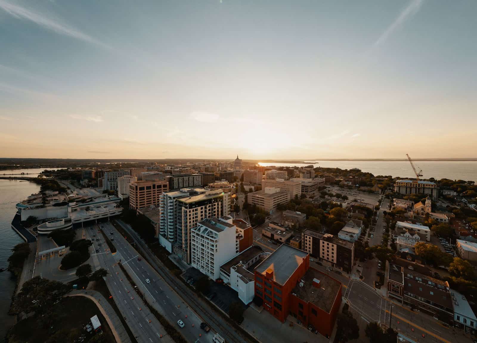 Breathtaking aerial view of Madison, Wisconsin's cityscape during a serene sunset.