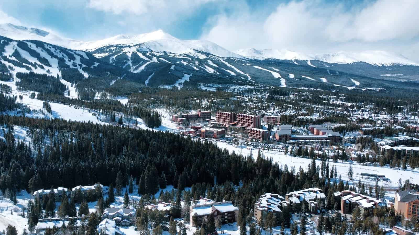 A stunning aerial view of Breckenridge, Colorado, showcasing snow-covered mountains and a winter landscape.