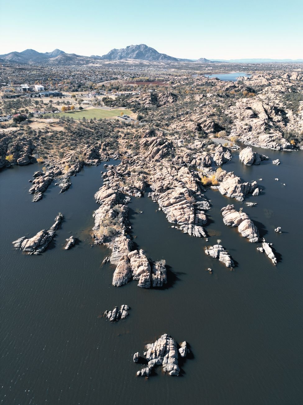 Stunning aerial shot of the Granite Dells rock formations in Prescott, Arizona under clear skies.