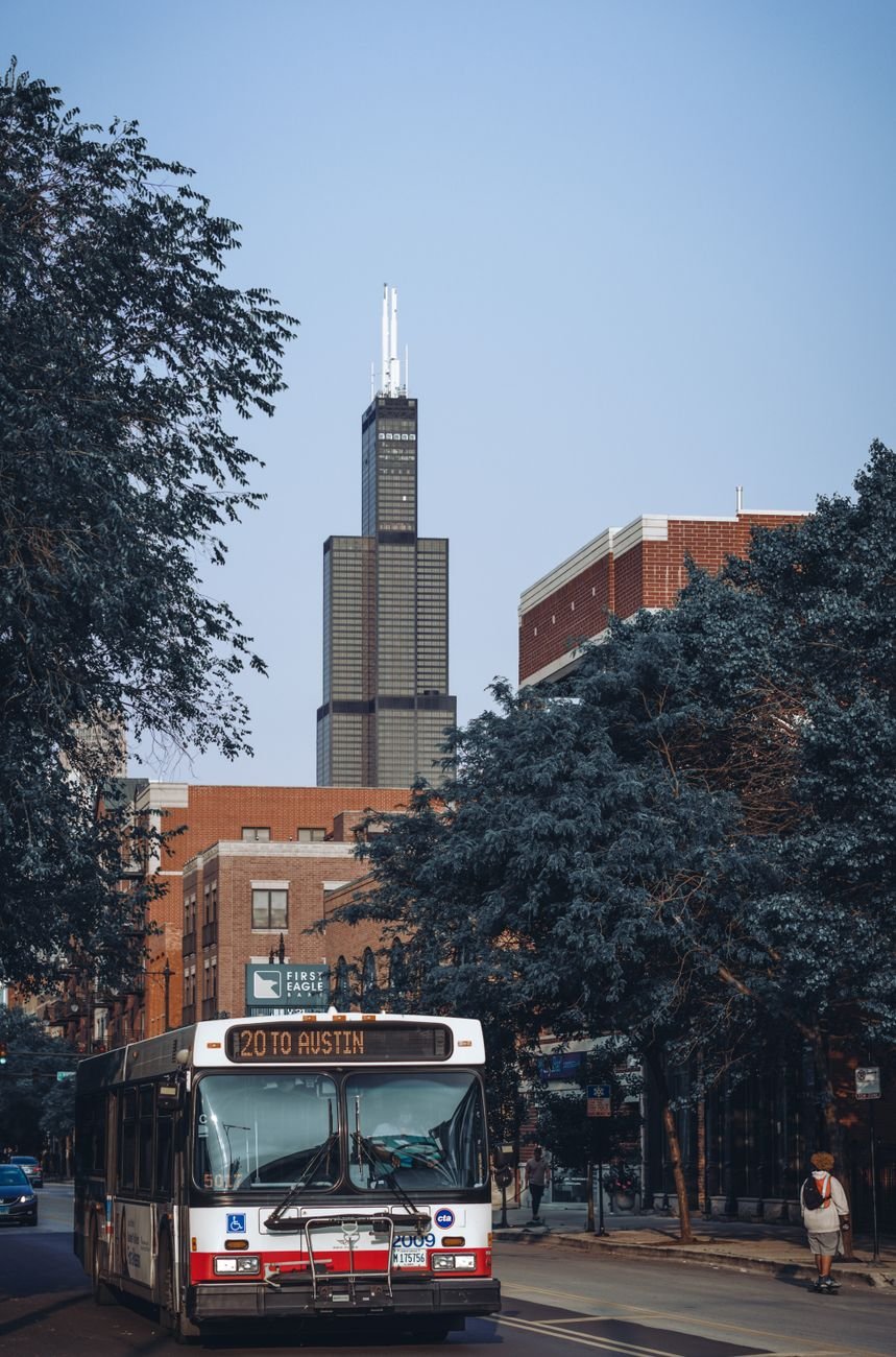 Urban street scene in Chicago featuring a bus and the iconic Willis Tower.