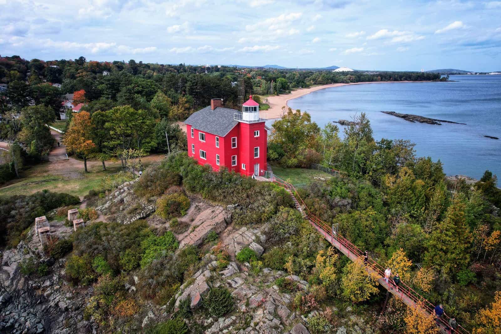 Discover the iconic Marquette Harbor Lighthouse against the scenic Lake Superior shore.