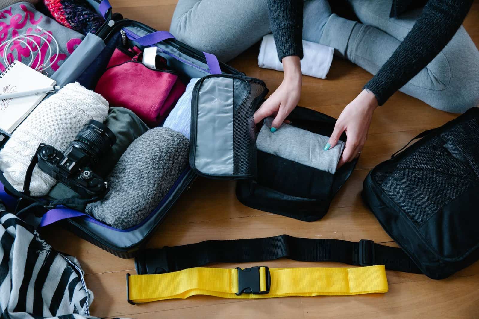 Open suitcase with organized travel packing items
