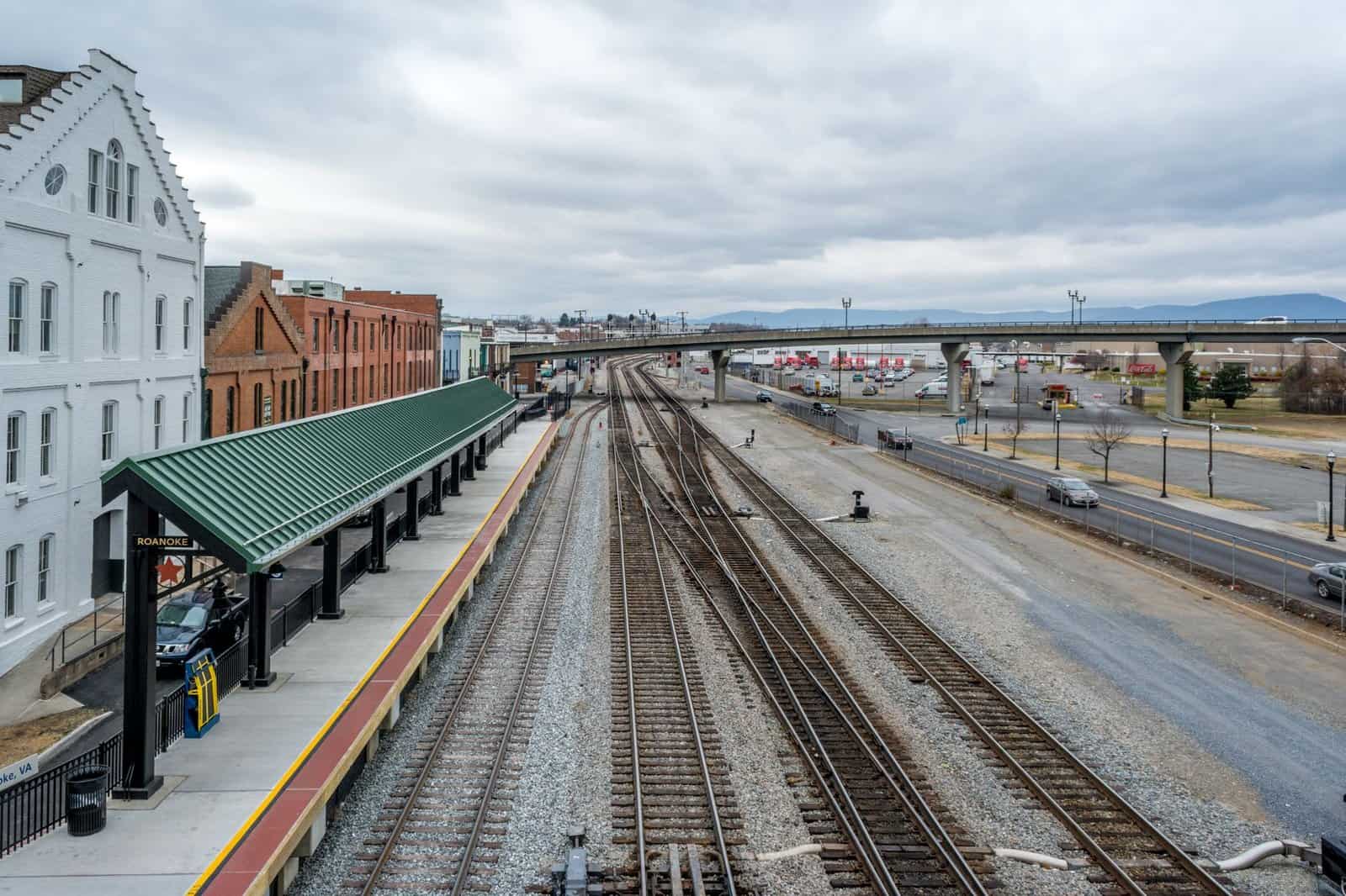 Elevated view of Roanoke train station with railway tracks, showcasing urban transportation infrastructure.