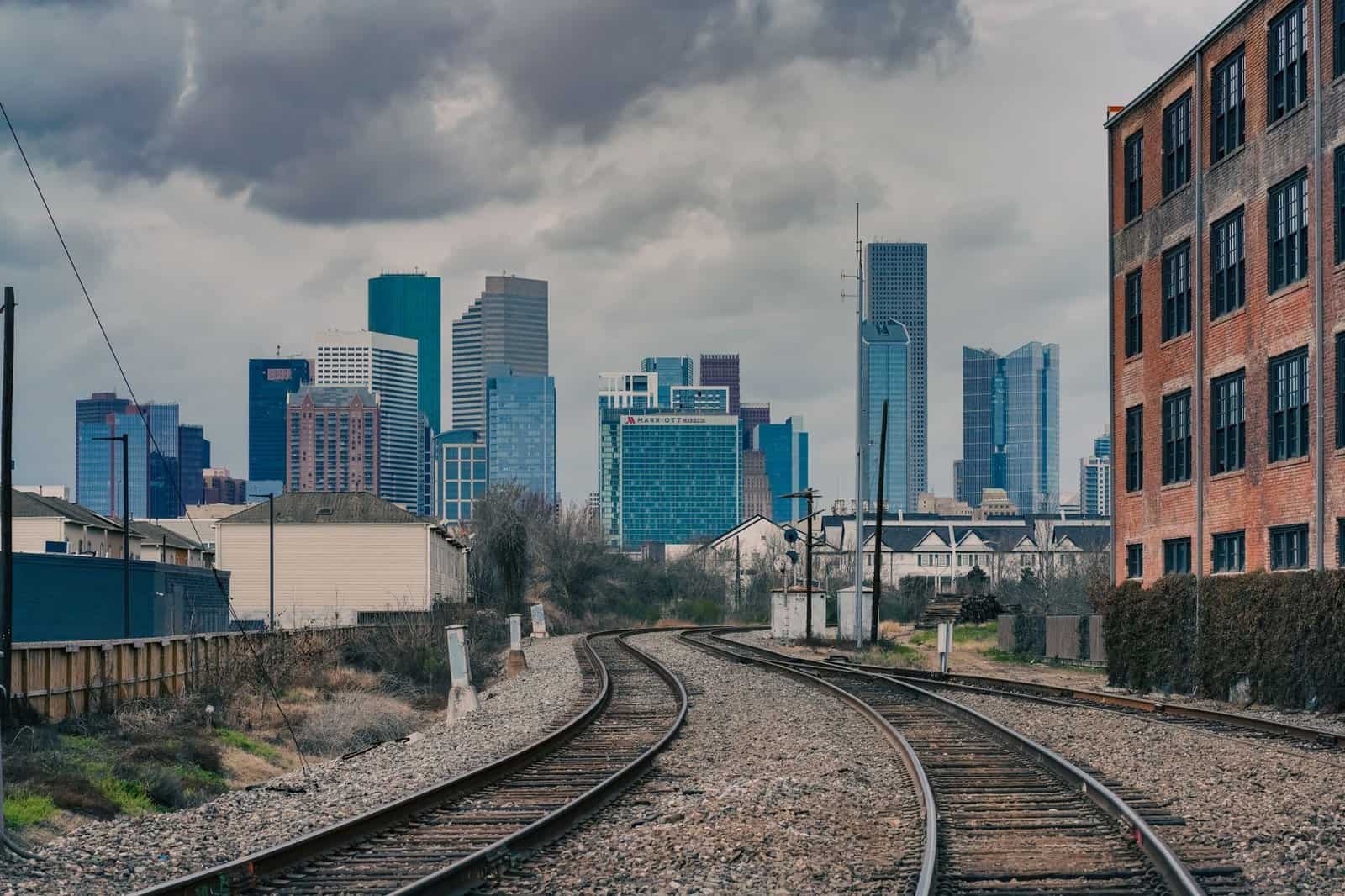 Dramatic view of Houston's skyline from a railway perspective, showcasing urban charm.