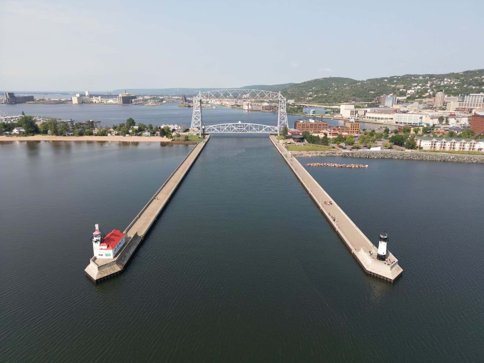 A stunning aerial shot of Duluth's iconic Aerial Lift Bridge and surrounding harbor on a clear day.