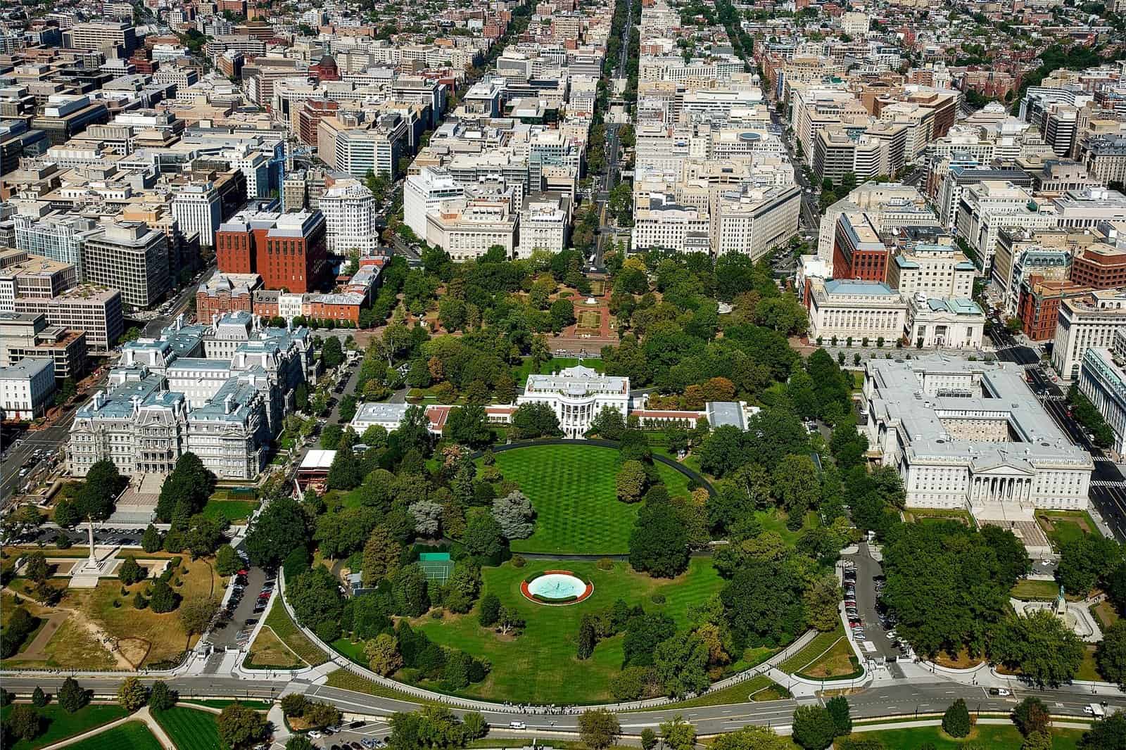 A stunning aerial view of The White House surrounded by downtown Washington D.C.'s architecture and green spaces.