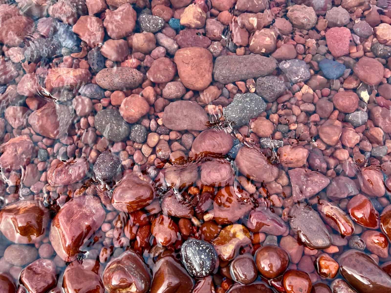 Vibrant multicolored stones underwater at Copper Harbor, Michigan shoreline.