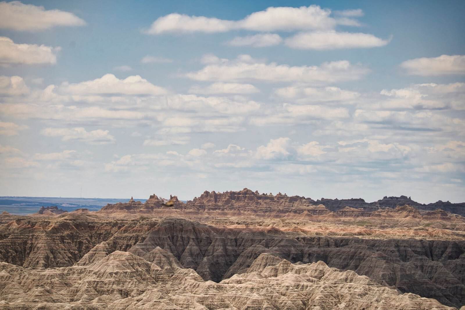 Dramatic landscape of Badlands National Park under a cloudy sky.